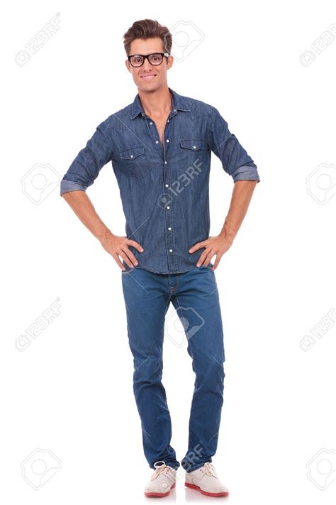Casual Young Man Holding His Hands On His Hips While Smiling