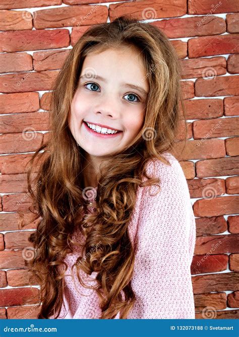 Portrait Of Adorable Smiling Standing Little Girl Child Stock Photo