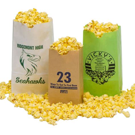 Three Bags Filled With Popcorn Sitting On Top Of A Pile Of Yellow And