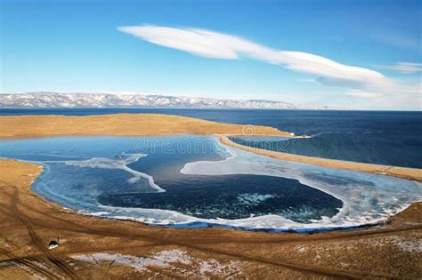 Frozen Lake Khankhoy On The Island Of Olkhon And Unfrozen Lake Baikal