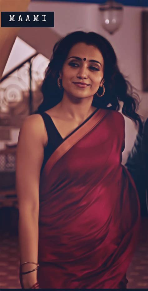 a woman in a red sari posing for the camera
