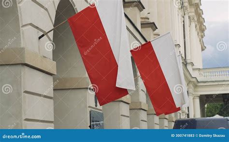Polish Flags Flutter In The Wind Against A Building In The City Center