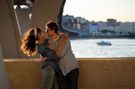 Two Lovers Kiss At Sunset Happy Stylish Couple Embrace Lovely Young Man And Woman Hug In