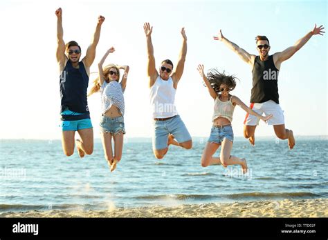 Happy Friends Jumping At The Beach Outdoors Stock Photo Alamy