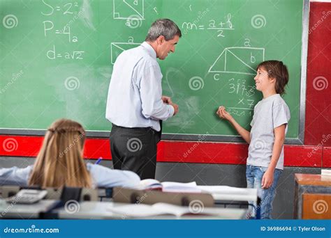 Schoolboy Asking Question To Teacher While Solving Stock Photo Image