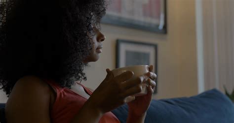 Young Black Woman Drinking Coffee And Relaxing In The Morning Stock