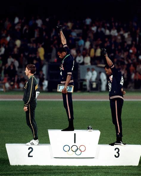 Gold medalist tommie smith (center) and bronze medalist john carlos (right) showing the raised fist on the podium after the 200 m race at the 1968 summer olympics; Australia Peter Norman (silver), USA Tommie Smith (gold ...