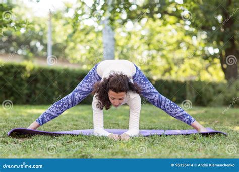 A Slim Woman In The Park Making Beautiful Asana Exercises Sporty Woman