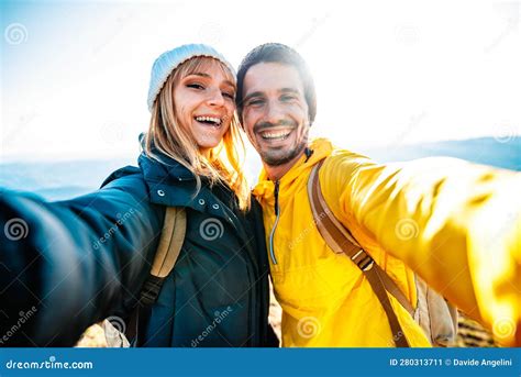 Couple Of Hikers Taking A Selfie Climbing Mountains Man And Woman
