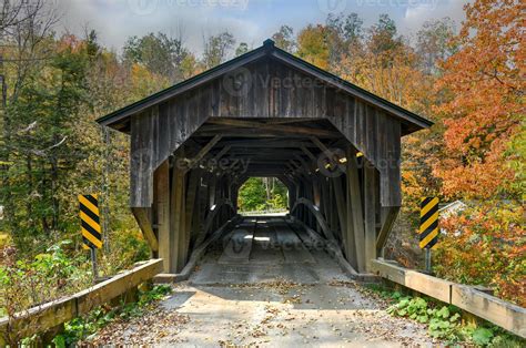 Grist Mill Covered Bridge In Cambridge Vermont During Fall Foliage