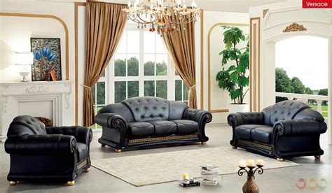 Living room suite, includes cushioned sofa, 2 decorative pillows, 2 cushioned armchairs, coffee table, vase, and bouquet of flowers by calico critters. Versace Living Room Set | Black Leather Living Room Set