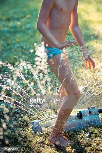 Girl Runs Through Sprinkler Bildbanksbilder Getty Images