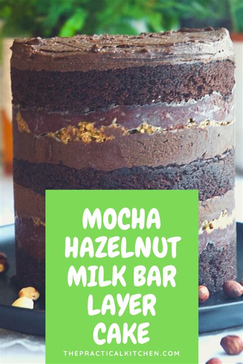 There Is A Chocolate Cake With Nuts On The Top And Green Sign That Says