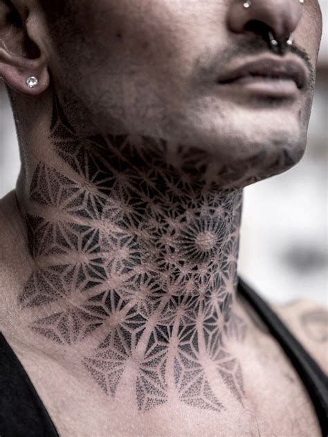 A Man With Tattoos On His Neck And Chest