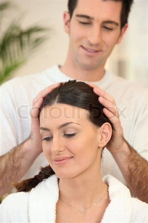 man giving his wife a head massage stock image colourbox
