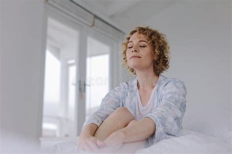 Mature Woman Sitting On Bed With A Digital Tablet Stock Photo Image