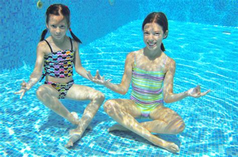 Happy Active Kids Play Underwater In Swimming Pool Stock Photo