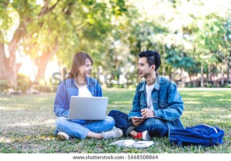 Asian Student Couple Studying Outside On Stock Photo 1668508864