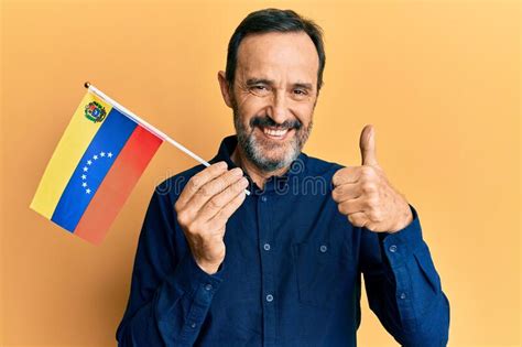 Middle Age Hispanic Man Holding Venezuelan Flag Smiling Happy And