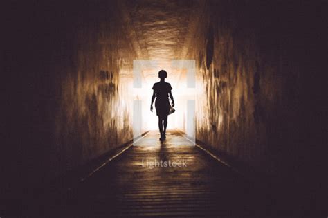 Woman Walking Into The Light — Photo — Lightstock
