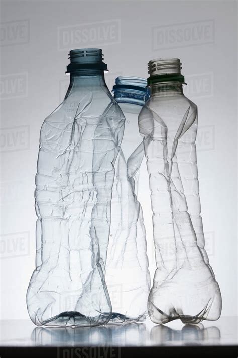 Three Empty Partially Crushed Plastic Water Bottles Stock Photo Dissolve