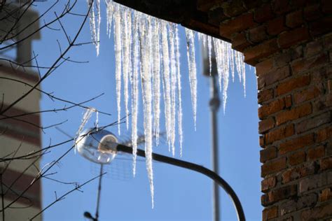 Large Icicle Hanging From Roof Stock Photos Pictures And Royalty Free