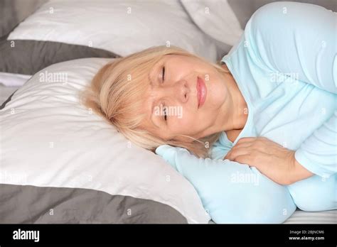 Beautiful Mature Woman Sleeping In Bed At Home Stock Photo Alamy