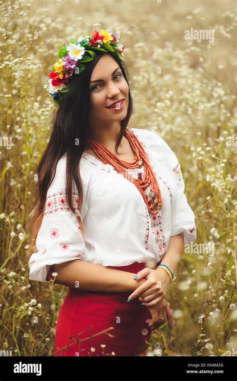 Beautiful Woman In Colorful Ukrainian Traditional Dress Holding Herself And Enjoying Summer In
