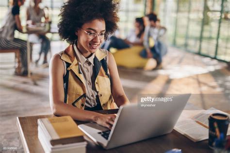 Young Happy Black Student Using Laptop While Learning For Her Exams
