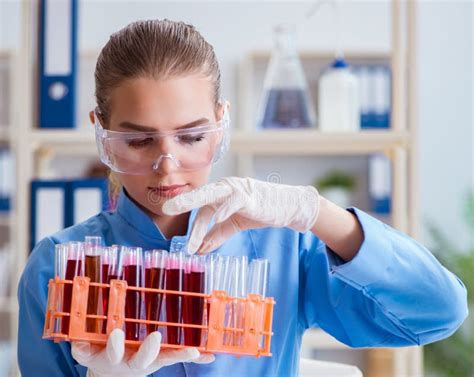 Female Scientist Researcher Conducting An Experiment In A Labora Stock