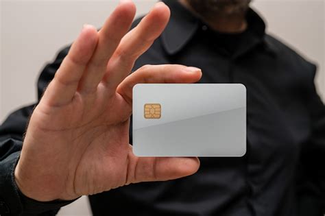 Man Holding A Blank Credit Card In Hands Stock Photo Download Image