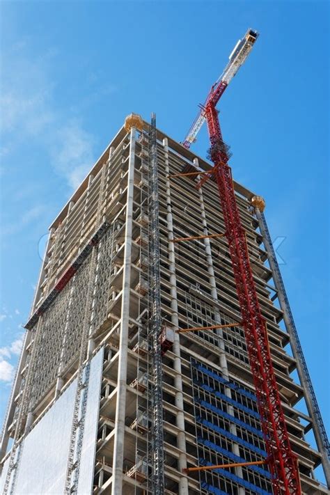 Lifting Crane And High Building Under Construction Stock