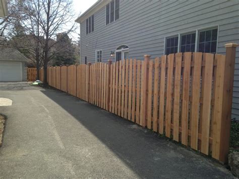 Custom Board On Board Arched Fence That Runs Along A Driveway Fence