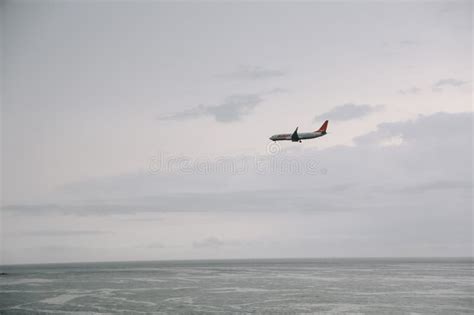 A Plane Flying In The Sky In The Rain Jeju Island South Korea