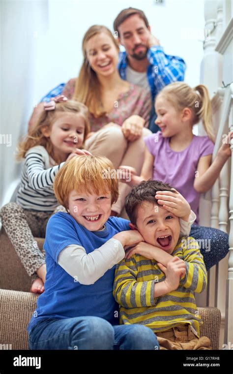 Happy Parents And Children Sitting On Staircase Stock Photo Alamy