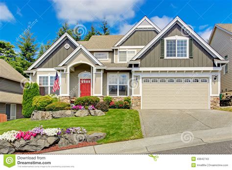 American House With Beautiful Landscape And Vivid Flowers Stock Image