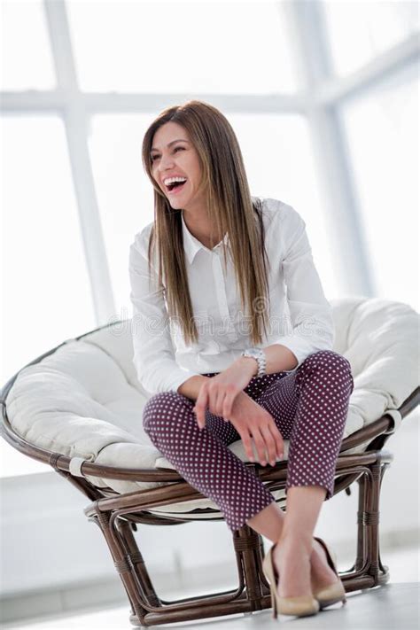 Modern Young Woman Sitting In Comfortable Round Chair Stock Image