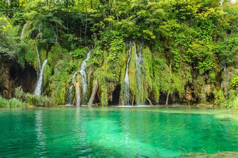 Waterfalls Over The Turquoise Waters Of The Lake Natural Environment