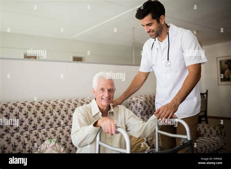 Nurse Helping Senior Man To Stand Up Stock Photo Alamy