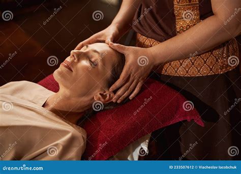 Experienced Masseuse Stimulating Acupoints On Her Patient Head Stock