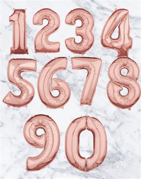 Rose Gold Foil Balloons In The Shape Of Numbers And Numerals On A