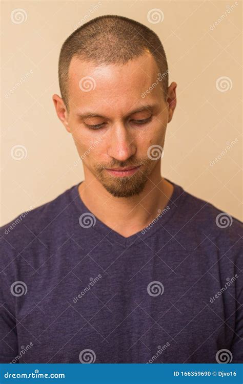 Portrait Of A Brooding Young Man In A Blue Or Purple Photoball Against