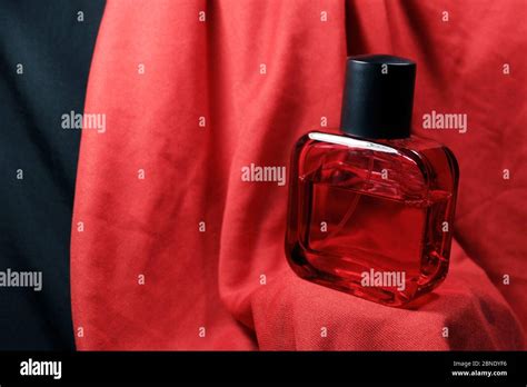 Red Color Men Perfume Bottle Isolated On Red Silk Background Red