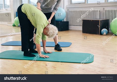 Senior Woman Bending Forward Touching Her Stock Photo 232770412