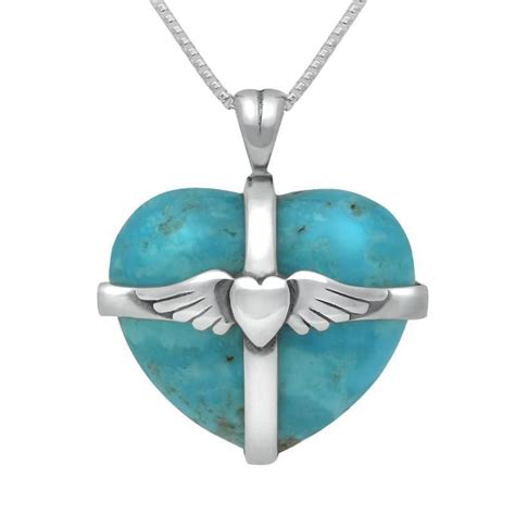 A Heart Shaped Pendant With Wings And A Cross In The Center On A White