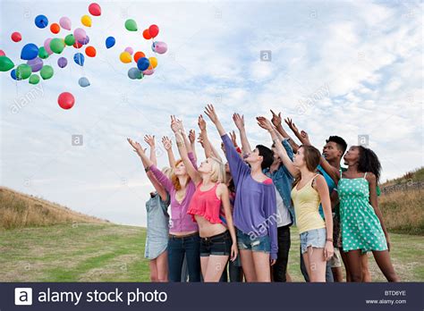 Young people releasing balloons Stock Photo: 32252962 - Alamy