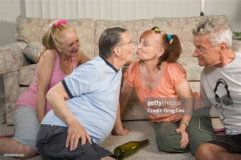 Senior Couples Playing Spin The Bottle Side View Closeup High Res Stock