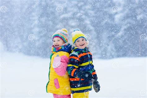 Kids Playing In Snow Children Play In Winter Stock Photo Image Of