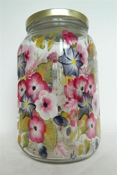 A Glass Jar With Flowers Painted On It
