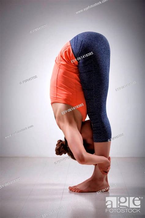 Beautiful Sporty Fit Yogini Woman Practices Yoga Asana Uttanasana